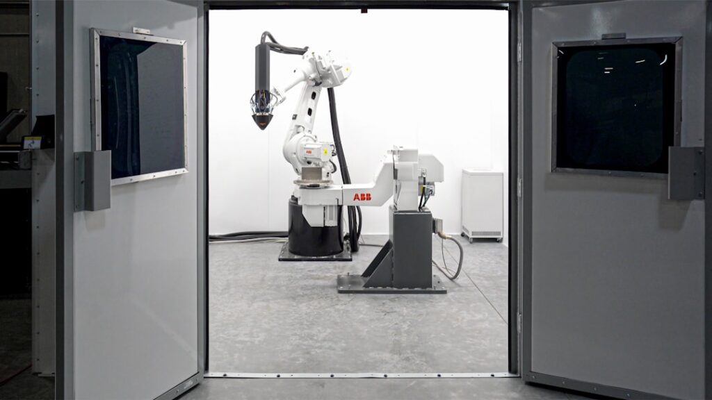 Large-format additive manufacturing equipment. Photo by Hermeus on Unsplash.