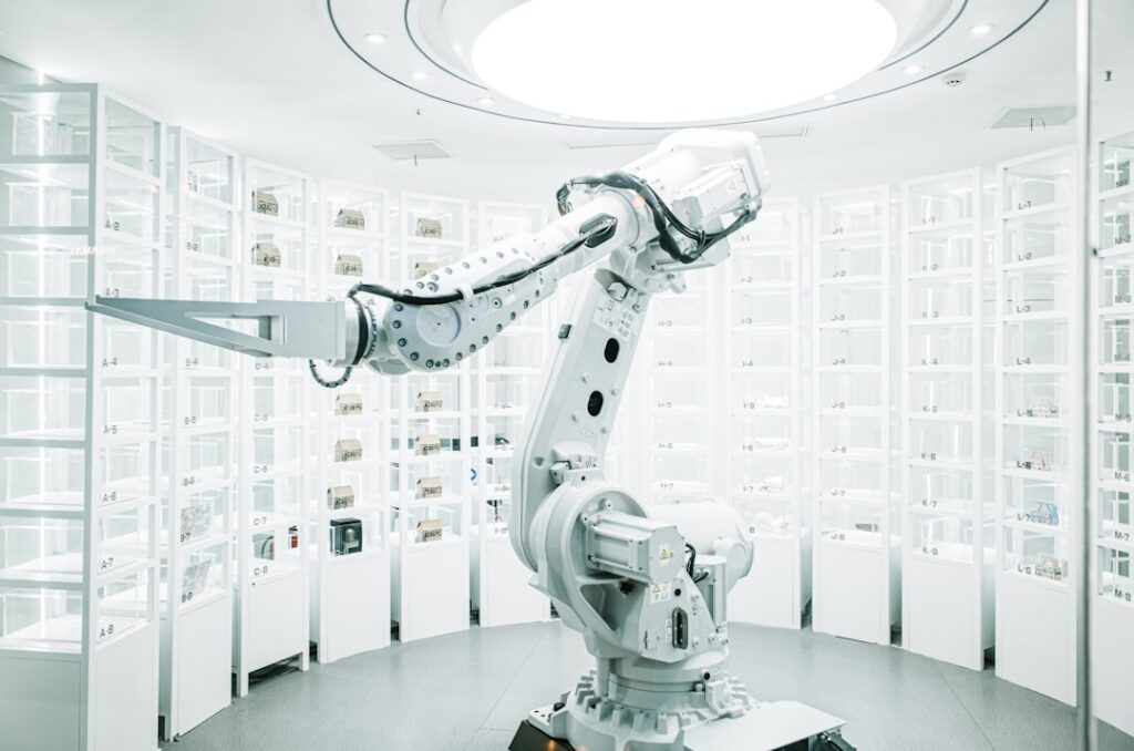 White robotic arm in a modern technology laboratory. Photo by ZHENYU LUO on Unsplash.