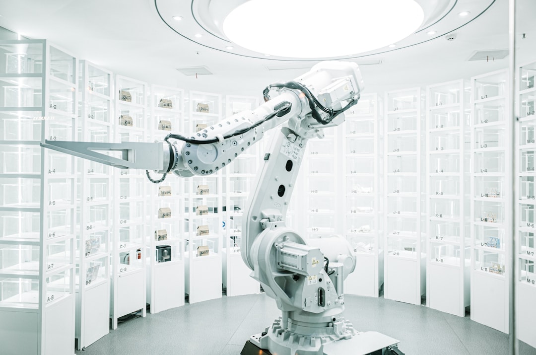 White robotic arm in a modern technology laboratory. Photo by ZHENYU LUO on Unsplash.